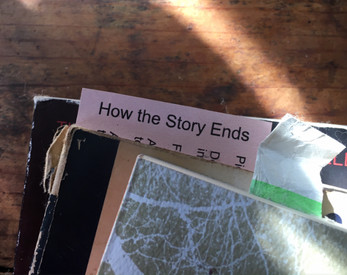 a card used as a bookmark: How the Story Ends